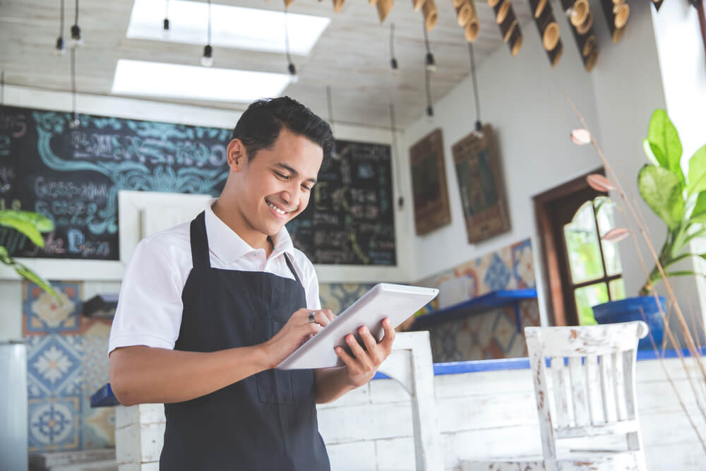 Business owner using iPad to promote small business